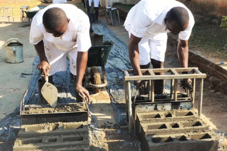 Inmates being drilled in modern block making